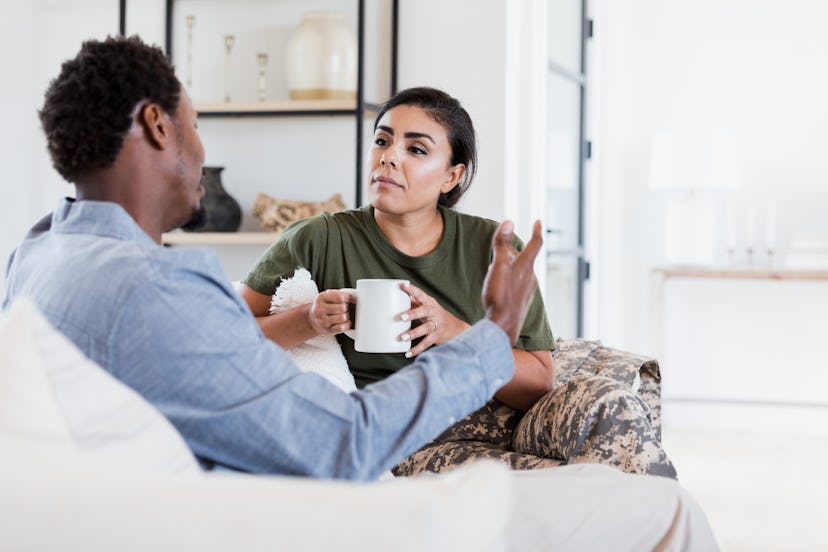 An attentive female soldier listens as her husband discusses something serious. High IQ Highly gifte...