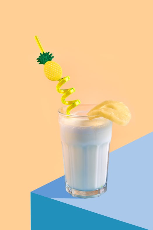 High angle view of pina colada or pineapple smoothie on yellow.