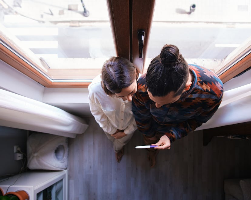Couple seen from above wait for ovulation test results and when to have sex