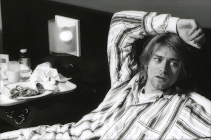 Kurt Cobain of Nirvana, lying in bed wearing pjs.