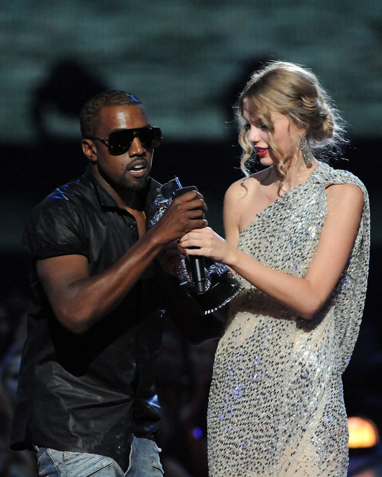  Kanye West (L) jumps onstage as Taylor Swift accepts her award for the "Best Female Video" 