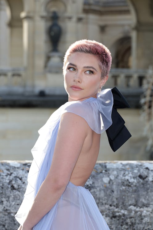 Florence Pugh debuted a pink buzz cut hairstyle at the Valentino Haute Couture Fall/Winter 2023/2024...