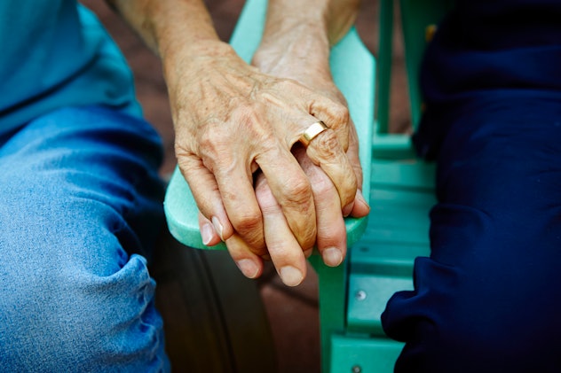 closeup of older couple holding hands in article about sexy things long-term couples do