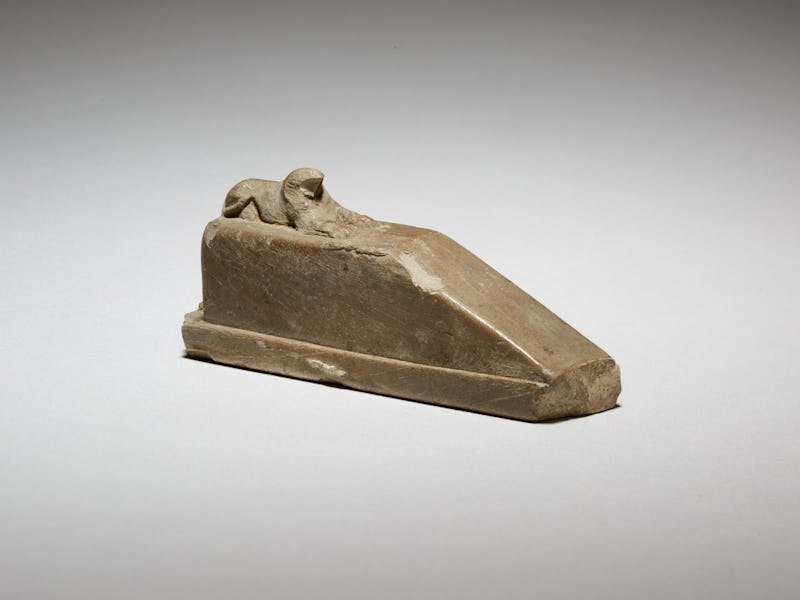 Falcon-headed sphinx recumbent on a pedestal with a ramp, and a feline(?) behind, possibly a gnomon ...