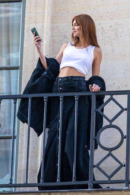 Kendall Jenner wears a white tank top and a denim maxi skirt in Paris. 