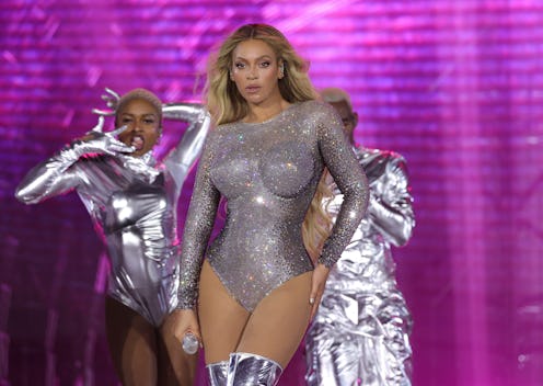 Beyoncé wears a silver bodysuit and metallic silver boots during her Renaissance World Tour. 