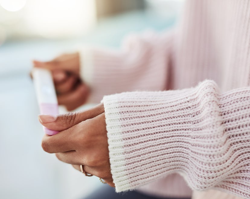 Cropped shot of an woman sitting on her bed wondering what a faint positive test result means