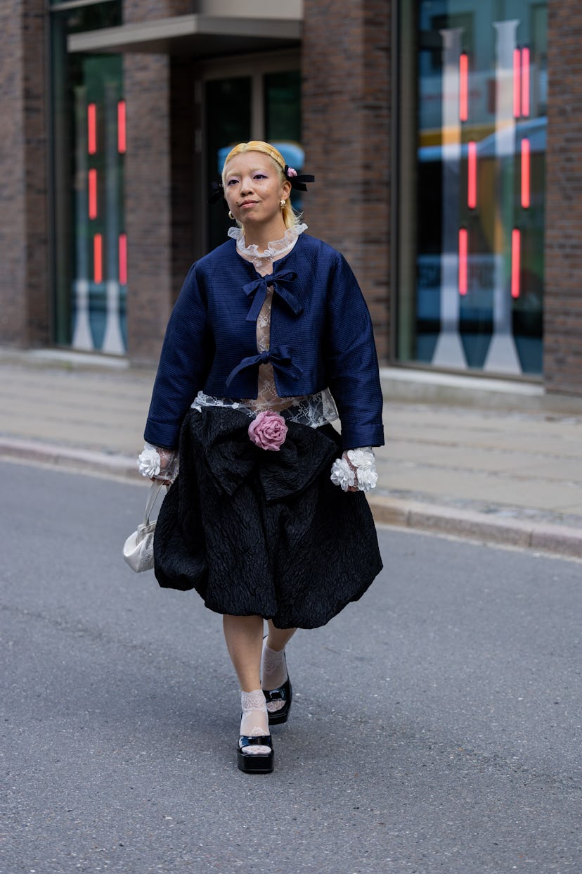COPENHAGEN, DENMARK - AUGUST 08: A guest wears blue jacket, skirt outside Lovechild during the Copen...