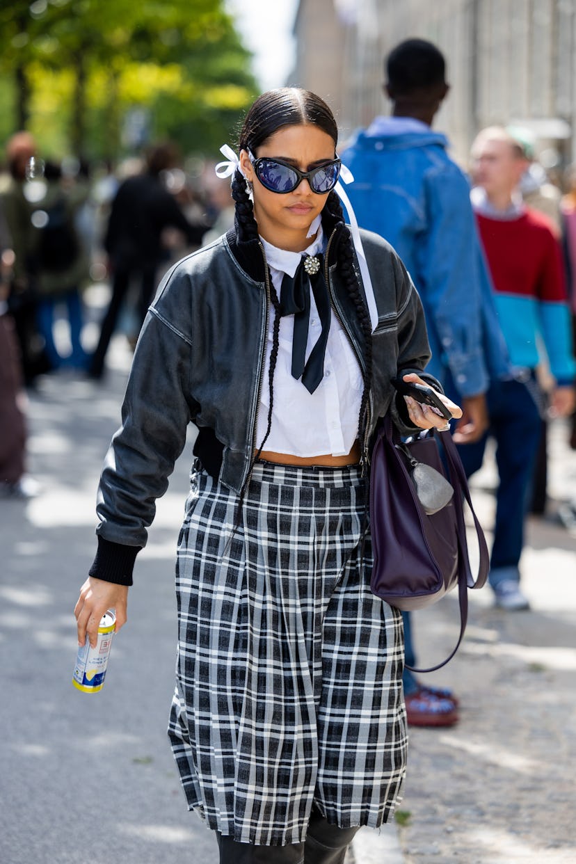 COPENHAGEN, DENMARK - AUGUST 08: A guest wears checkered black white skirt, jacket, white shirt outs...