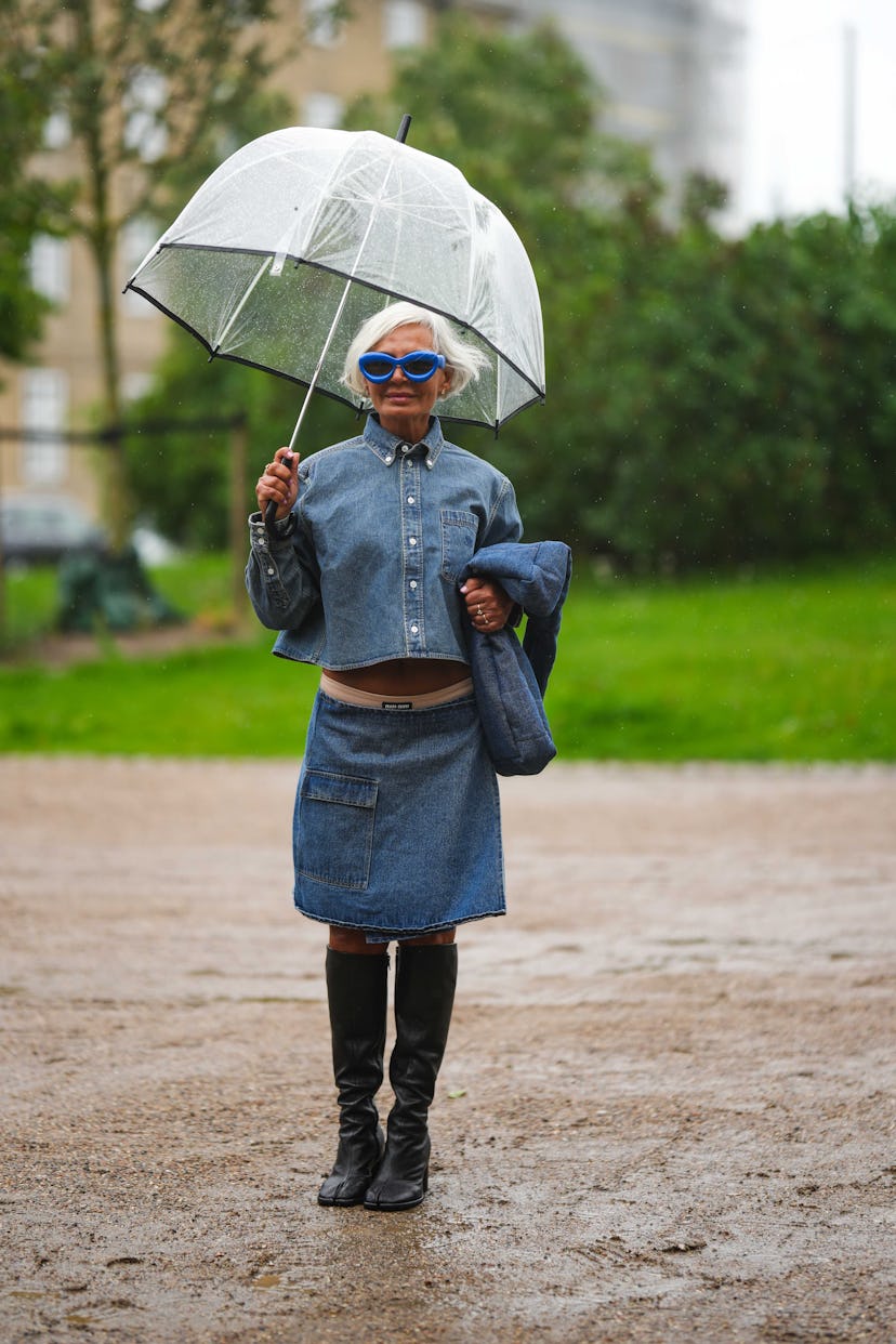 COPENHAGEN, DENMARK - AUGUST 09: Grece Ghanem wears a white transparent umbrella, royal blue sunglas...