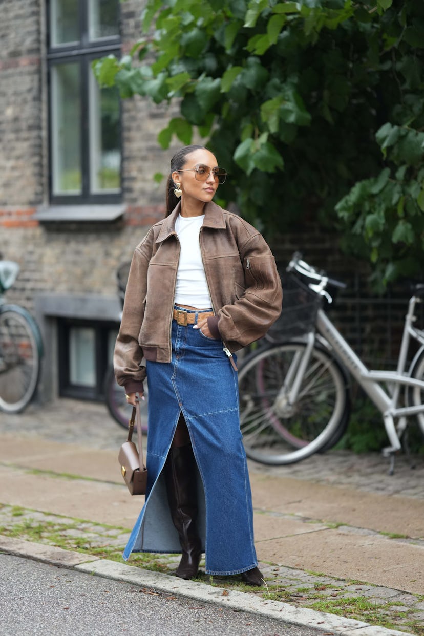 COPENHAGEN, DENMARK - AUGUST 09: A guest wears brown sunglasses, a white t-shirt, a dark brown faded...