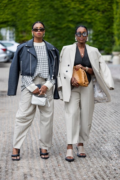 COPENHAGEN, DENMARK - AUGUST 10: Guests wearing beige suit, black leather jacket outside Munthe duri...
