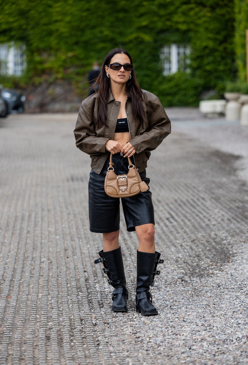 COPENHAGEN, DENMARK - AUGUST 10: Anna Winter wears brown leather jacket, shorts, bag, boots outside ...
