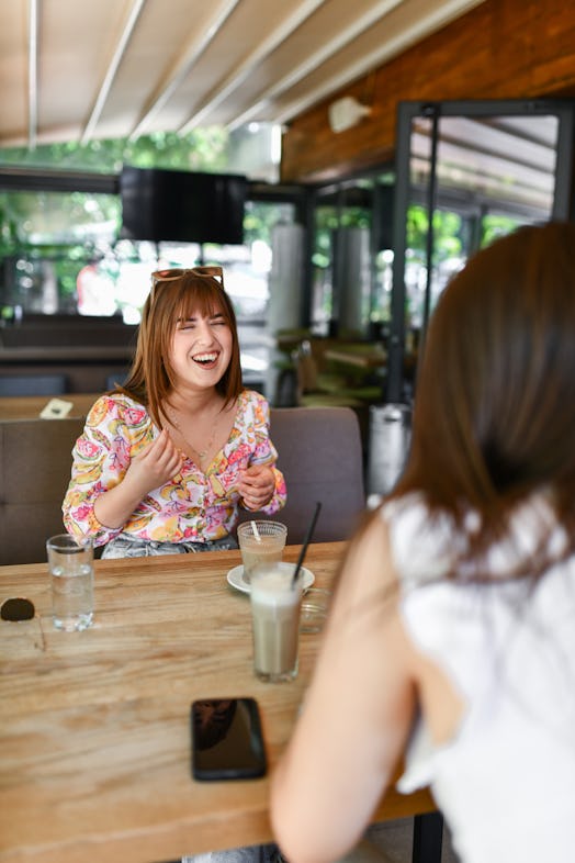 Fun Times For Cute Females Laughing During Conversation And Coffee