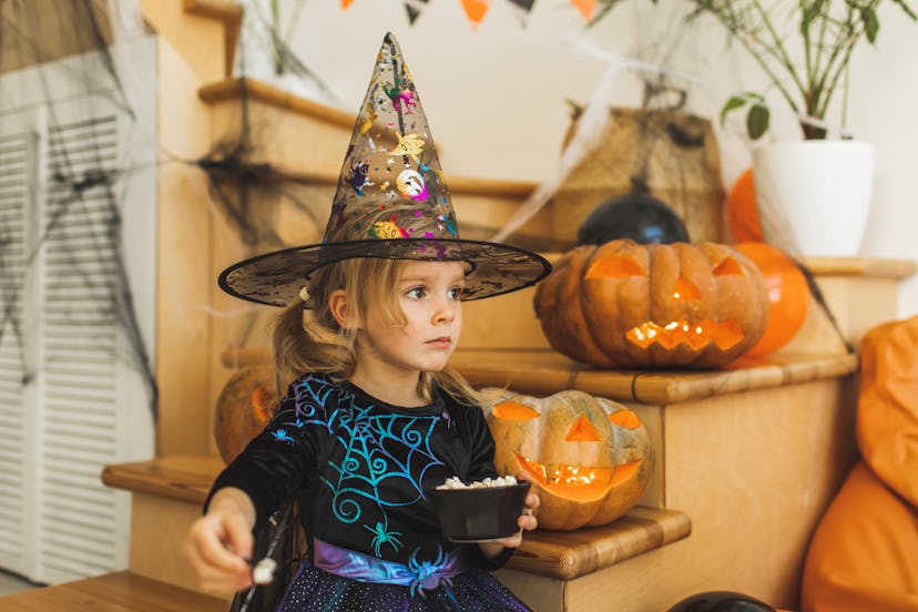 Happy child in fairy costume. Positive moments of childhood. House, decorated for halloween celebrat...