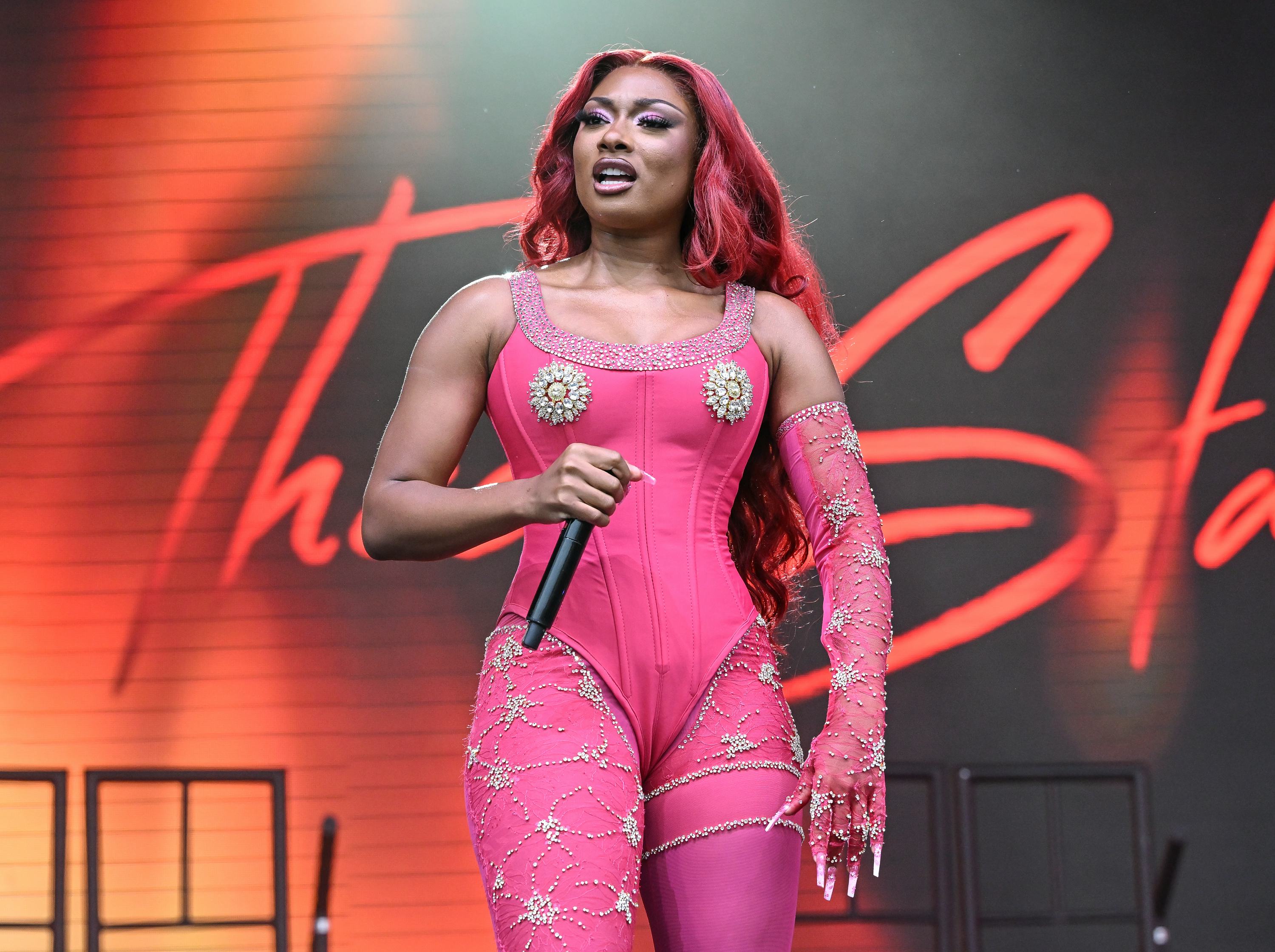 Megan Thee Stallion wears a pink corseted bodysuit, tights, and opera glove to perform at the 2023 O&hellip;