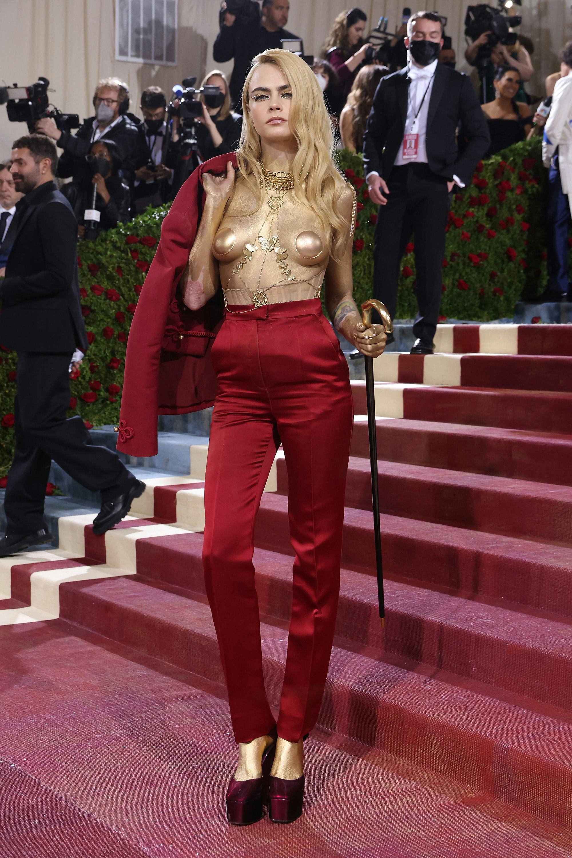 Cara Delevingne wears a red suit and gold pasties to attend &ldquo;In America: An Anthology of Fashion,&rdquo; t&hellip;