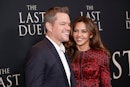 Matt Damon and his wife Luciana Barroso attend a movie premiere together. She wears a red dress and ...