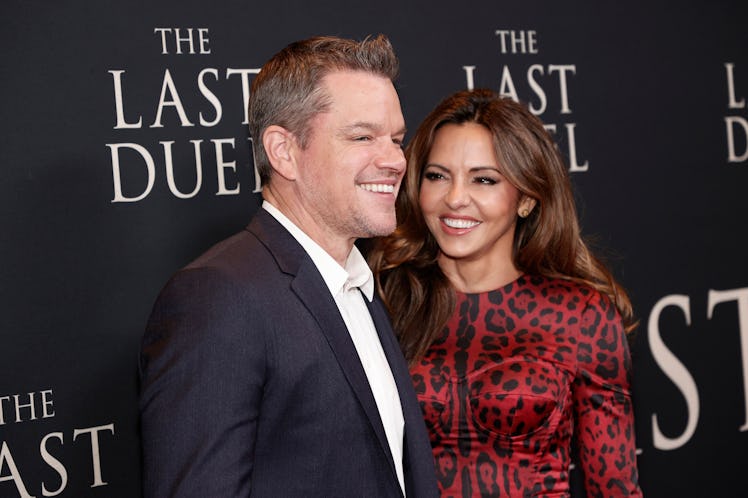 Matt Damon and his wife Luciana Barroso attend a movie premiere together. She wears a red dress and ...