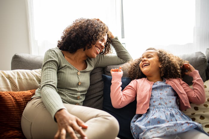 Mother and daughter having fun in the living room