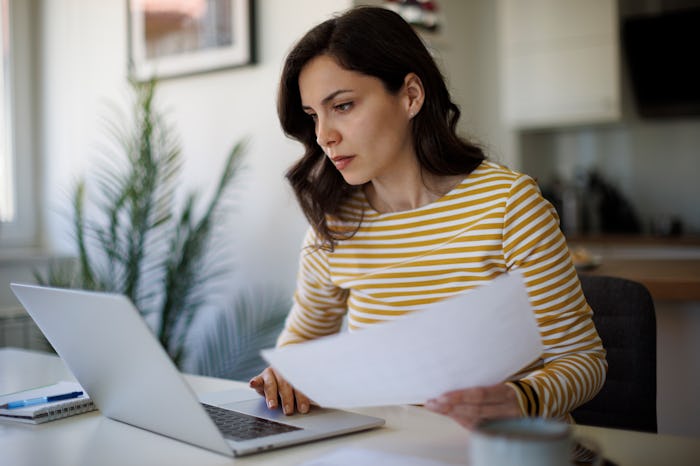 Serious young woman working at home