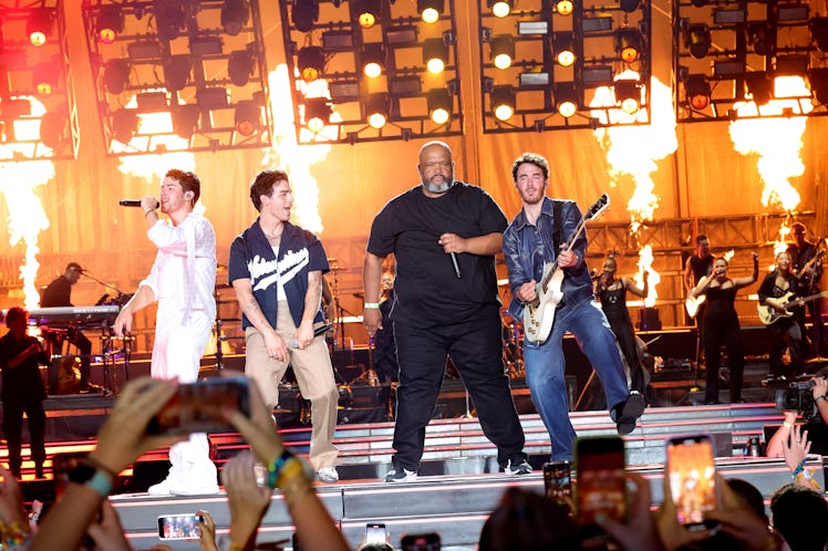 Nick Jonas, Joe Jonas, Robert "Big Rob" Feggans, and Kevin Jonas perform "Burnin' Up" onstage during...