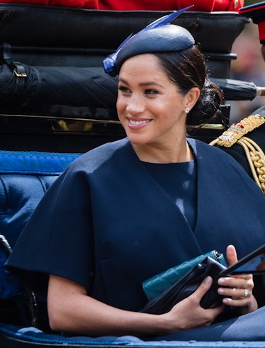 Meghan, Duchess of Sussex rides by carriage down the Mall during Trooping The Colour