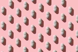 an image of a white pill on a pink background, in an article about zuranolone, the postpartum depres...