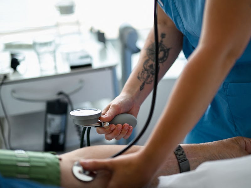 Nursing assistant 29-year Daria from Ukraine measures the blood pressure of a patient at the St. Joh...
