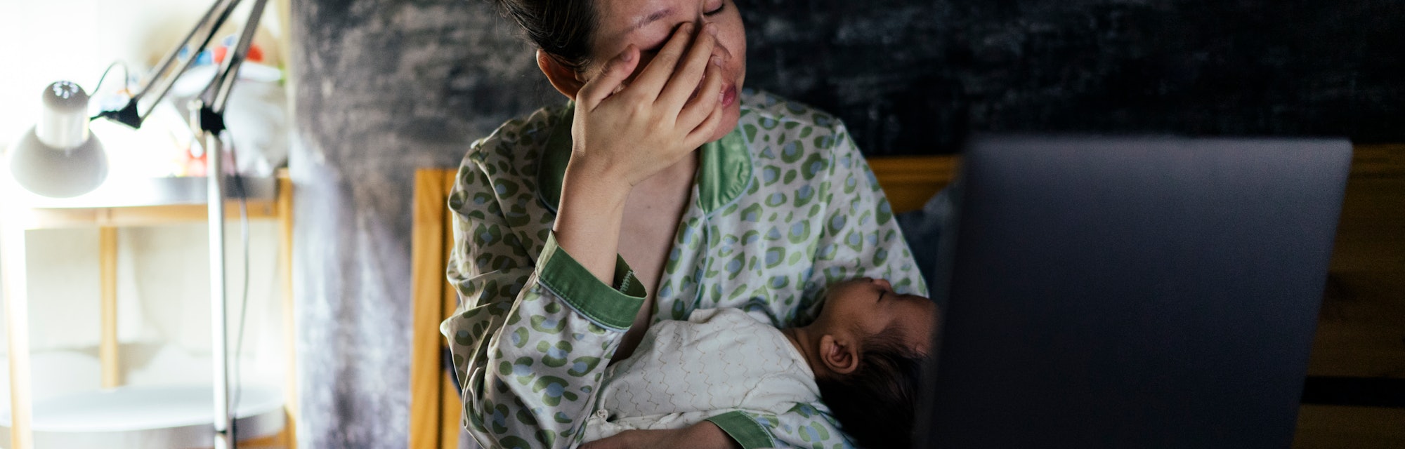 a mom breastfeeding in the night, in an article about when you can stop breastfeeding at night