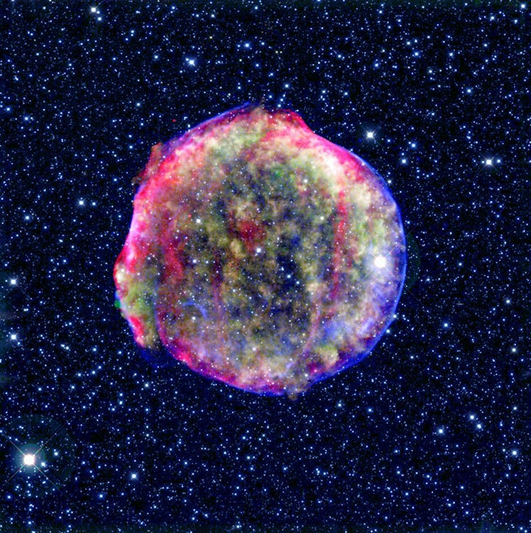 A composite image of the Tycho supernova remnant. Spitzer and Chandra space observatories. It shows ...