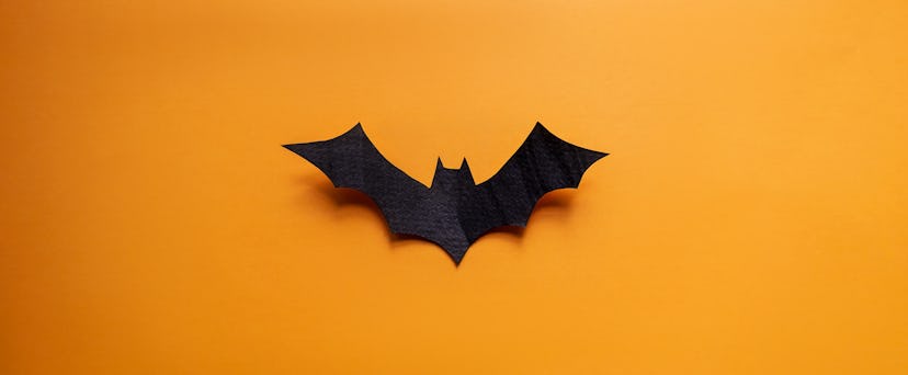 cut-out bat on orange background in halloween knock knock jokes roundup