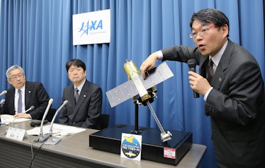 Takashi Kubota (R), space program director of the Japan Aerospace Exploration Agency (JAXA), answers...