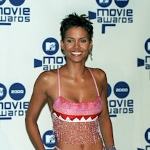 Halle Berry wears a pink crop top and mini skirt with a built-in whale tail to attend the 2000 MTV M...