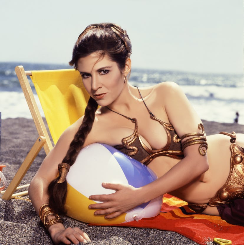 Carrie Fisher as 'Princess Leia' in gold bra. 