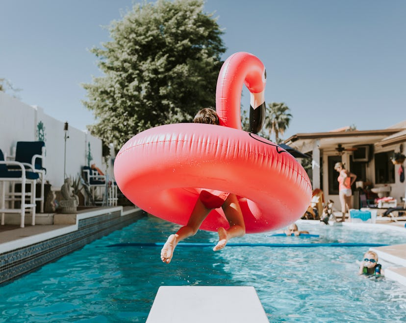happy photo of kid jumping in pool with flamingo tube in roundup of labor day photo captions