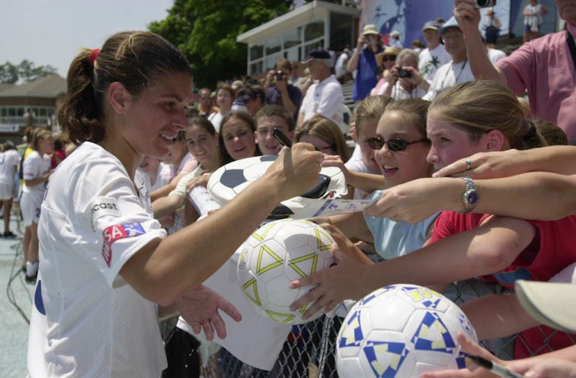 Mia Hamm #19 of the Washington Freedom signs autographs before a game against the Carolina Courage a...