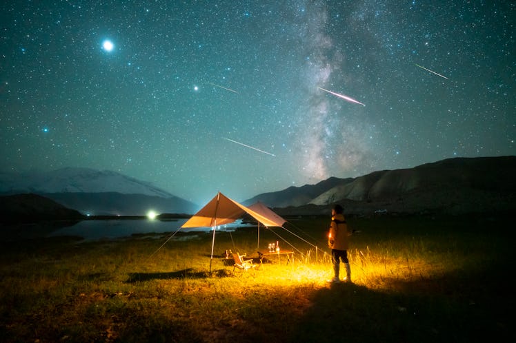 XINJIANG, CHINA - AUGUST 13: A man watches the Perseid meteor shower on the Pamir Plateau on August ...