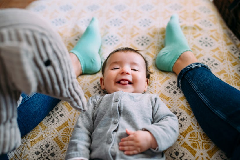 A baby sticks her tongue out playing with Mom, in a story answering the question, why do babies stic...