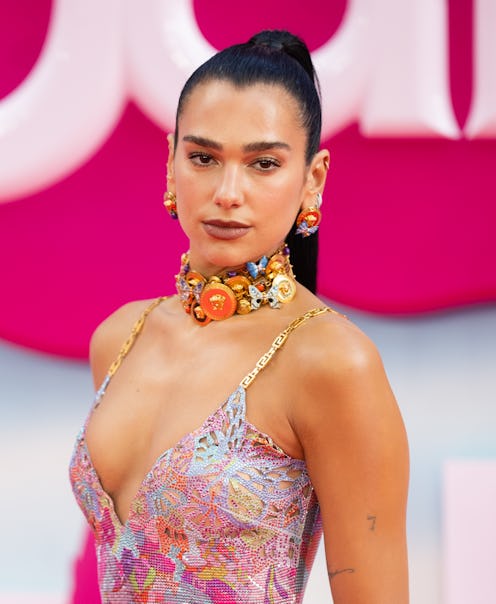 Dua Lipa wears a sleeveless crystal-encrusted dress to attend the "Barbie" European Premiere.