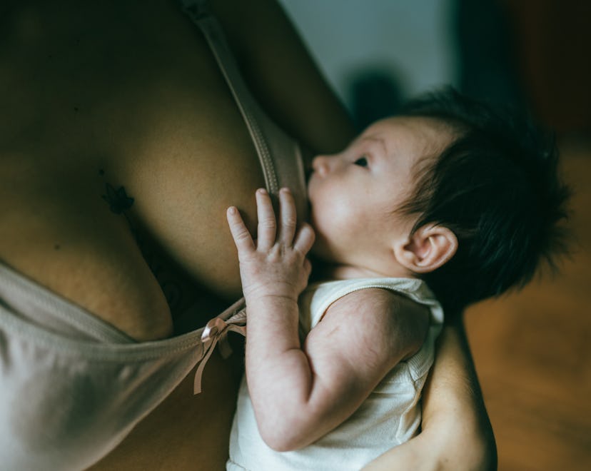 Close-up of baby being breastfed, in a round up of lactation consultants most common breastfeeding q...