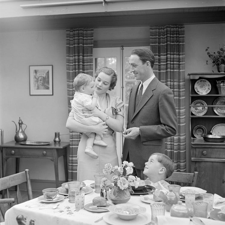 UNITED STATES - CIRCA 1930s: Family at breakfast in dining room.