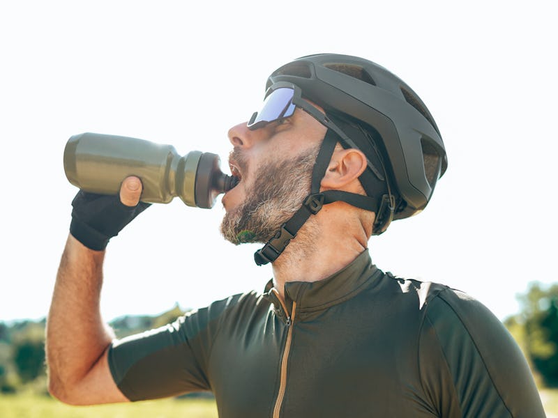 cyclist drinking water on the countryside