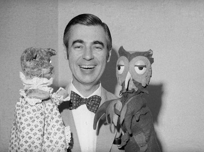 Fred Rogers of Mister Rogers' Neighborhood holds Henrietta Pussycat (left) and "X" the Owl during an...