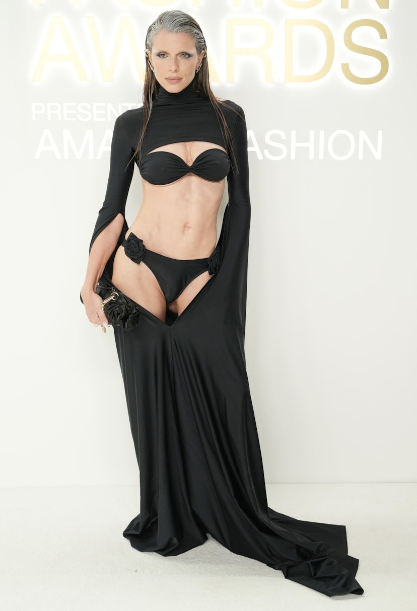 Julia Fox wears a black dress, bra, and thong to attend the CFDA Fashion Awards.