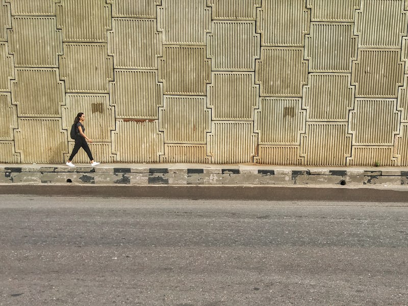 A Girl walks alone near a Flyover on a hot day in New Delhi, India, on 10 July 2019. (Photo by Nasir...
