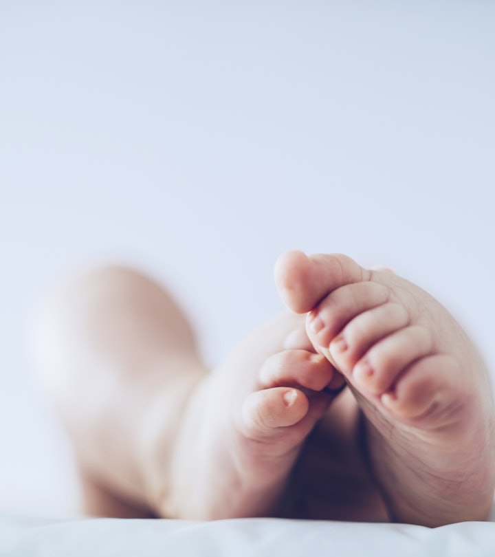 Baby feet up in the air lying down in article about angel baby meaning