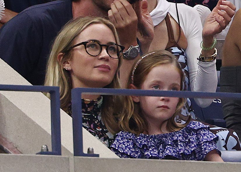 Emily Blunt cuddles up with her daughter at the US Open.