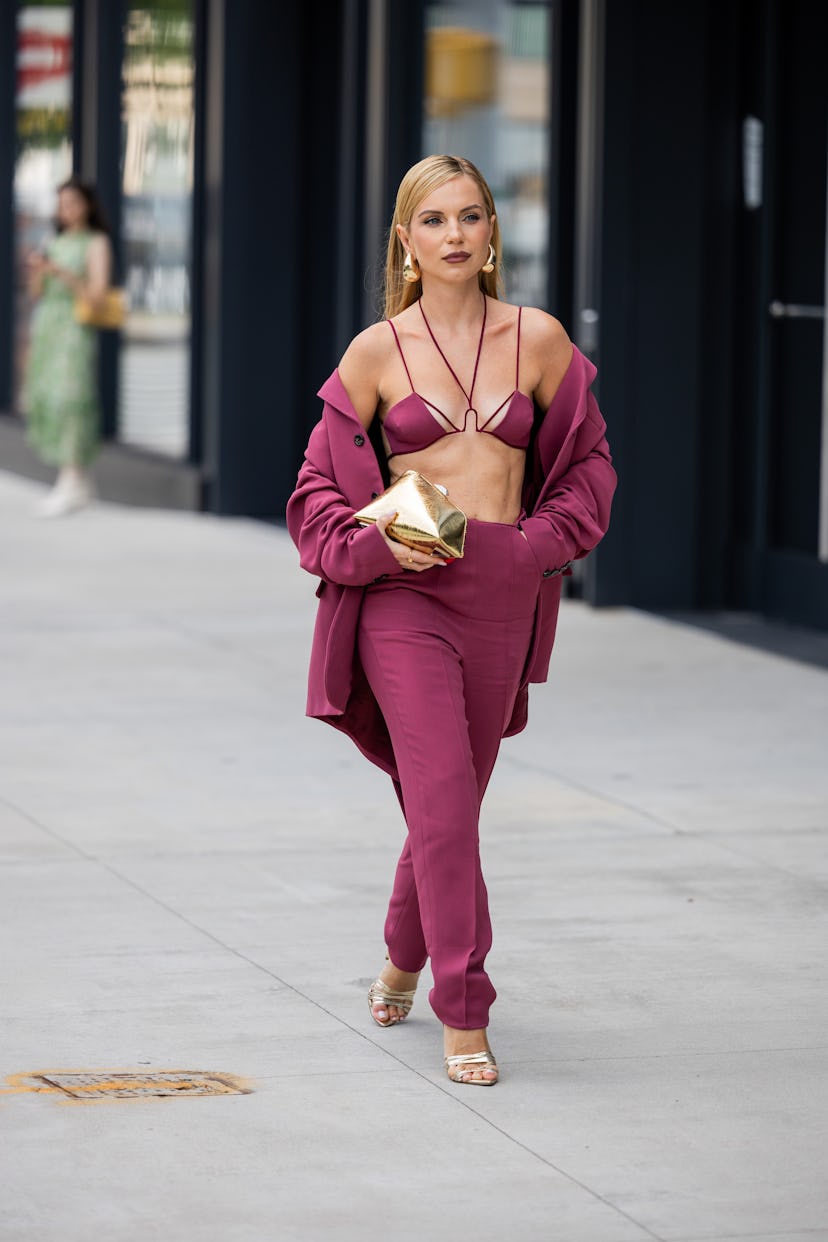 NEW YORK, NEW YORK - SEPTEMBER 09: A guest wears burgundy cropped top, pants, jacket outside Bevza o...