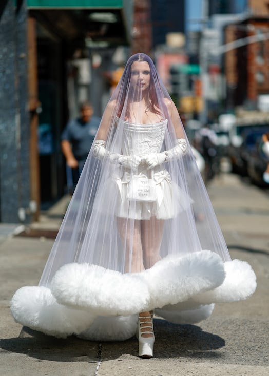 Julia Fox wears a wedding gown, veil, and gloves to Wiederhoeft's NYFW show. 